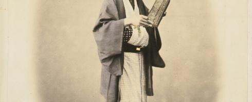 Japanese merchant, identified as "Mr Shojiro", holding an abacus, taken between 1867 and 1869. Flickr/National Library NZ on the Commons